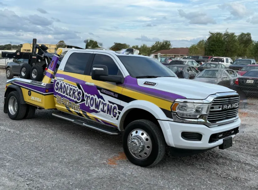 Purple and gold Sadler's Towing Ram 5500 wrecker
